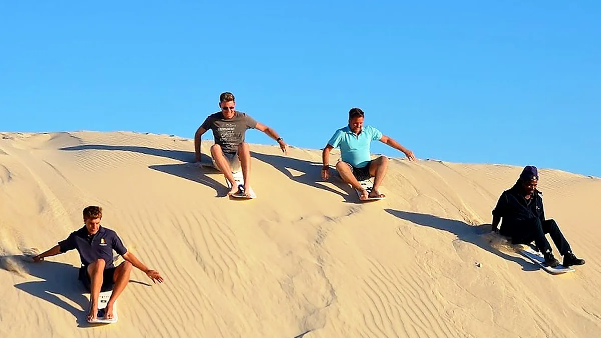 Sandboarding on a desert dune
