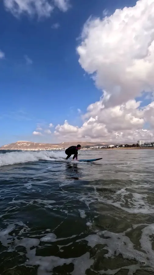 A surfer riding a wave in Morocco — Surf and desert: Agadir to Merzouga and back